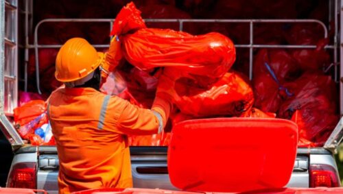 Medical waste containers and staff using a medical waste management system for safe disposal and tracking.