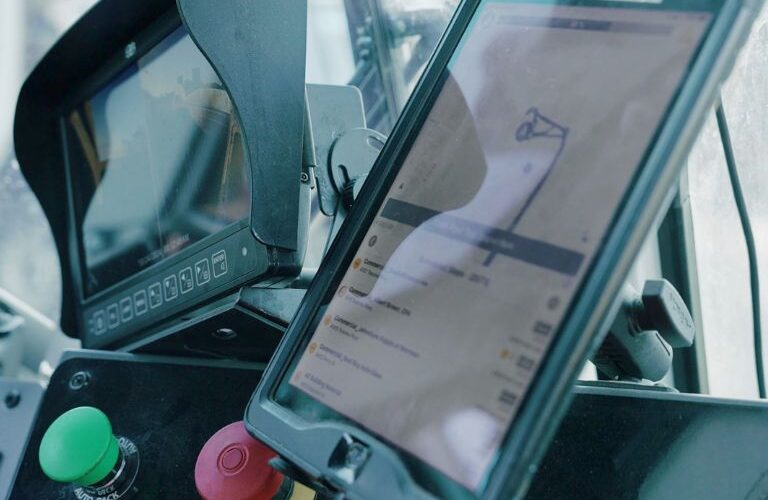 Fleet trucks and dashboards showing waste hauling service analytics and real-time route performance.